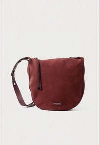 Burgundy suede shoulder bag with a rounded shape, featuring a zip closure, two decorative strings, and a textured strap.