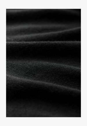 Black fabric with a soft texture, featuring subtle creases and a smooth finish, composed of tightly woven fibers.