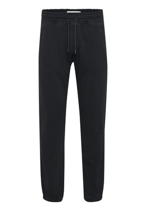 Pantaloni jogger neri realizzati in un morbido tessuto elasticizzato. Presentano una cintura elastica con cordoncino regolabile e caviglie a coste.