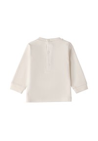 Camicia a maniche lunghe color crema con orlo dritto, chiusura con un bottone e texture morbida. Design semplice senza motivi o dettagli.