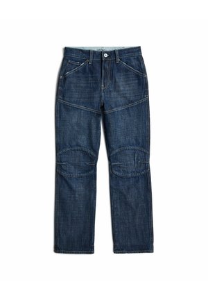 Ciemnoniebieskie dżinsy z denimu z łatkami na kolanach, przednimi kieszeniami, szlufkami na pasek i zapięciem na guziki, położone na płasko na białym tle.