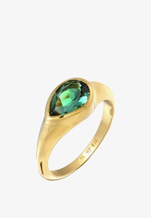 Goldfarbener Ring mit einem birnenförmigen grünen Edelstein. Glatter Ring mit polierter Oberfläche, verziert mit Edelstein-Schliff für zusätzlichen Funkeln.