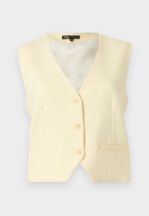 Veste sans manches crème à boutons avec encolure en V et deux poches avant, étiquette taille 36 à l'intérieur du col.