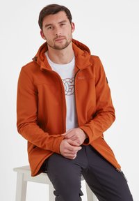 Orange softshell jacket with a zippered front and adjustable hood. Features a contrasting inner lining and logo on the chest.