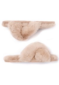 Fuzzy beige pull-on slippers with a crossed fur strap design, soft texture, and a flat sole. Lightweight and casual style.