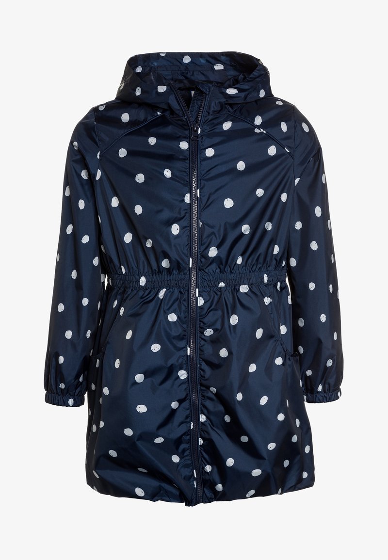 Marinblå vattentät jacka med vita prickar, elastisk midja, huva och två sidofickor med rynkade ärmslut.