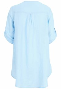 Light blue, linen blouse with a round neckline, three-quarter sleeves, and a center back pleat; curved hemline at the sides.