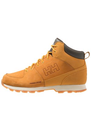 Tan leren wandelschoen met bruine accenten, gevoerde enkel, ronde veters, rubberen zool en logodetail aan de zijkant. Premium leren materiaal.