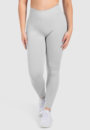 Leggings taille haute gris clair en tissu extensible avec une taille côtelée, texture lisse et forme ajustée.