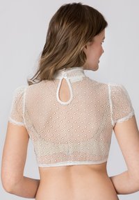 Gekürztes Spitzenoberteil in Cremeweiß mit kurzen Ärmeln und einem Stehkragen. Verfügt über einen Schlüsselaugen-Rücken und einen Knopfverschluss mit einem filigranen Blumenmuster.