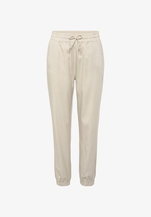 Pantalones jogger de color beige claro con cintura elástica, cordón ajustable, bolsillos laterales y puños elásticos. Tela suave, corte relajado.