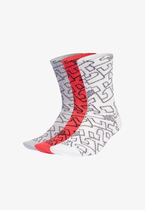 Three pairs of mid-calf socks in white, red, and gray, each with a black abstract geometric pattern throughout.