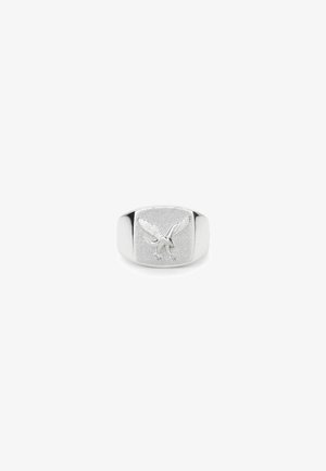 Silver signet ring with a textured surface, featuring an embossed eagle design. Smooth edges and a polished band enhance its appearance.