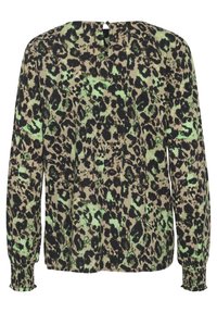 Long-sleeve blouse in a leopard print pattern featuring black and green hues on a beige background, with smocked cuffs and a back keyhole closure.