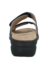 Black sandal with three wide straps, cushioned beige insole, and a chunky black platform sole. Textured surface with stitched detailing.