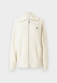 Cardigan de malha cremoso com nervuras, fecho com zip e colarinho largo, e um discreto detalhe de logo no lado esquerdo do peito. Tecido texturizado.