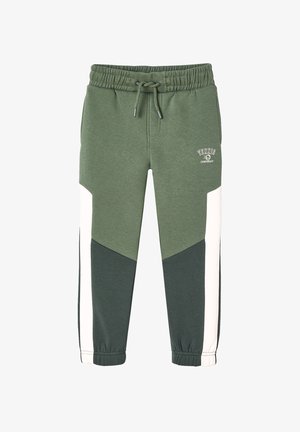 Green and white color-block joggers with an elastic waistband, drawstring, and tapered legs featuring a triangle design and logo accent.