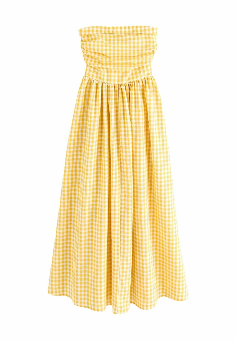 Vestido sin mangas de cuadros amarillos con un cuerpo fruncido, falda fluida y tejido de algodón texturizado. Presenta un diseño hasta la rodilla.