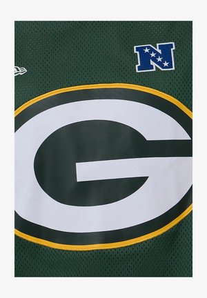 Maillot de football vert avec un grand logo "G" blanc bordé de jaune et un écusson bleu "N" avec des étoiles en haut à droite.