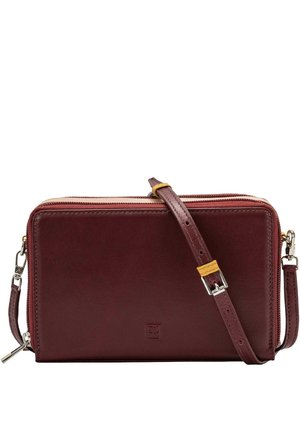Sac à bandoulière en cuir bordeaux avec une sangle réglable, fermeture à glissière et un petit logo de la marque à l'avant. Texture lisse, forme rectangulaire.