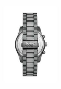 Gray metal watch with a link bracelet and a polished bezel. Features "MK" logo on clasp and a round, textured dial visible from the back.