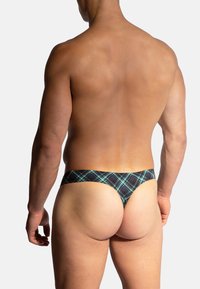 Schwarze und grüne Karomuster-Tanga-Unterwäsche mit einem tief sitzenden Bund, hergestellt aus dehnbarem Stoff, mit enganliegender Passform und minimaler Bedeckung.