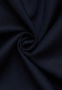 Marineblauwe stof met een geribbelde textuur, strak gedraaid in een spiraalpatroon, met een gladde glans en fijne details.