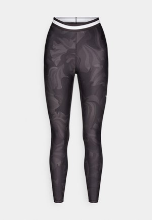 Leggings negros con un patrón gris en espiral, cinturilla elástica con rayas blancas y una textura ajustada y suave.