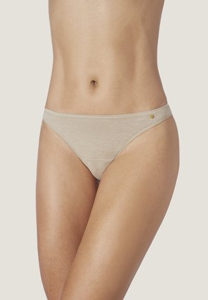Beige cotton thong with a soft texture, high-cut legs, and a low-rise waist. Features minimal stitching with a small logo accent on the side.