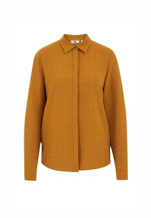 Dzeltena krāsa sinepju krekls ar strukturētu apkakli, garām piedurknēm un tekstūru, kas veidota no maziem kvadrātiem visā audumā.