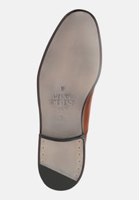 Braune Leder-Schuh mit einer glatten, abgerundeten Zehe. Die Sohle besteht aus hellbraunem Leder und einem schwarzen Gummibereich an der Ferse. Sichtbares, geprägt Markenlogo.