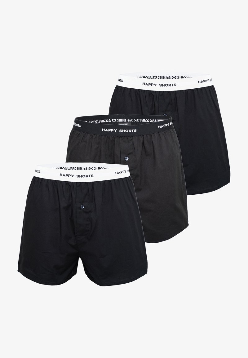Trois paires de boxers en mélange de coton doux. Les couleurs incluent le noir et le gris, avec une taille élastique, étiquetée "HAPPY SHORTS."