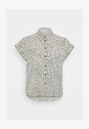 Kortermet skjorte med knapper i creme med sorte abstrakte pletter. Krave-designet, let buet kant og blød stofstruktur.