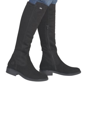 Knee-high black suede boots with a side zipper, flat rubber outsole, and a rounded toe. Features a logo accent near the heel.