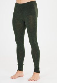 Gröna, åtsittande leggings tillverkade av ett strukturerat material. Har en hög midja och smalnande ben med subtila sömmar.