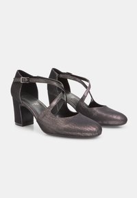 Black shimmer shoes with a rounded toe, block heel, and crisscross ankle strap. Textured surface and smooth interior lining.