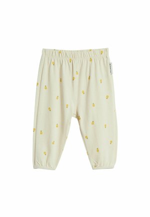 Babybukser i cremefarve med små gule ananasprint og elastisk talje og manchetter.