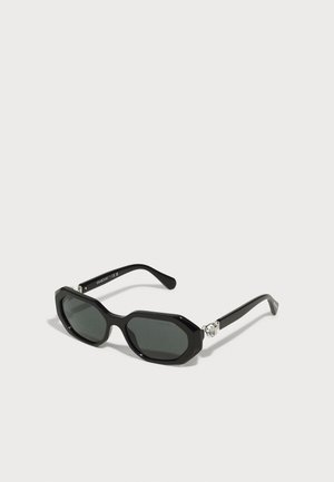 Schwarze Sonnenbrille mit achteckigem Rahmen, getönten Gläsern und glänzender Oberfläche. Verfügt über metallische Akzentdetails an den Bügeln.