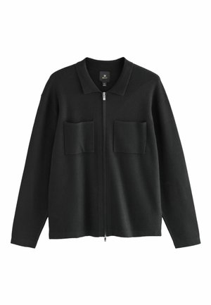 Black zip-up jacket made of soft, textured fabric. Features a collar and two front patch pockets. Relaxed fit with long sleeves.