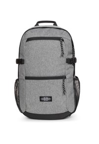Gray fabric backpack with two zippered front pockets, mesh side pockets, and black accents. Features a top handle and adjustable straps.
