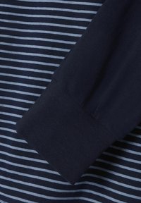 Navy striped shirt with light blue horizontal lines, featuring a solid navy cuff. Soft cotton material with a smooth texture.