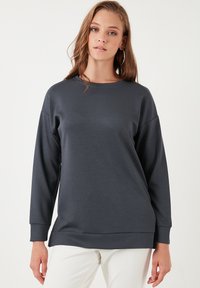Felpa a maniche lunghe grigio scuro con collo rotondo, caratterizzata da una vestibilità morbida, una texture liscia e un orlo dritto. Design minimalista senza motivi.