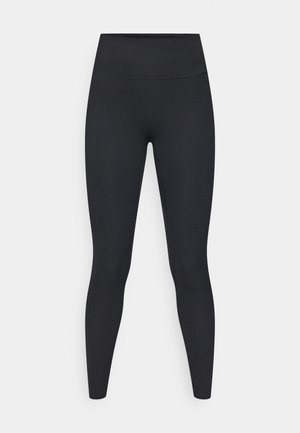 Leggings noirs avec une ceinture haute, fabriqués en tissu lisse. Ils présentent des jambes longues et aucun motif ou élément visible.