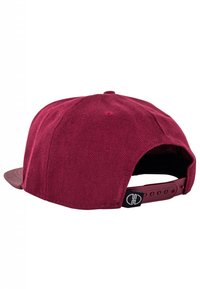 Maroon cap with a flat brim, textured fabric, adjustable snapback closure, and a black logo tag on the side.