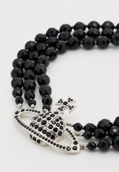 Μαύρο κολιέ με χάντρες, με πολλαπλές σειρές από διακοσμημένες χάντρες και ασημένιο μενταγιόν πλανήτη με μαύρες πέτρες και διακοσμητικό σταυρό.