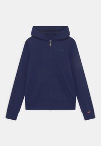 Navy blue zip-up hoodie made of soft fabric, featuring a front pocket, drawstring hood, and embossed logo on the chest.