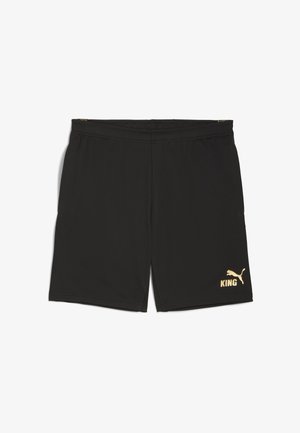 Fekete sportnadrág poliészterből, elasztikus derékpánttal, oldalsó zsebekkel és egy arany Puma logóval, rajta a "KING" szóval.