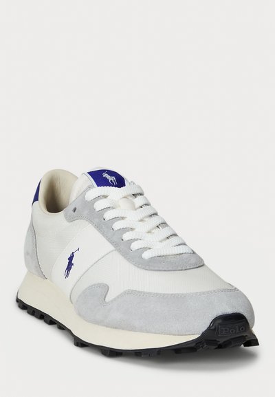 White and gray sneaker with blue Polo logo on side and tongue, white laces, and black textured sole, angled to show front and side.