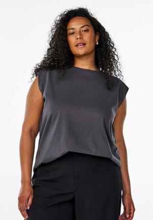 Dark gray sleeveless top with a relaxed fit, made from soft fabric. Features a round neckline and subtle drape at the hem. Paired with black pants.