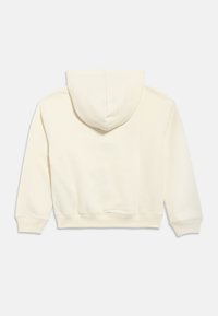 Krémovo sfarbená skrátená mikina s kapucňou, predným vreckom typu klokanka, dlhými rukávmi a sťahovacou šnúrou na kapucňu. Hladká zmes bavlny, minimálne švy.